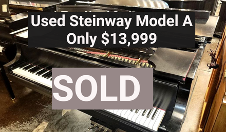 Used black Steinway Model A grand piano; text: "Used Steinway Model A, only $13,999. Sold"